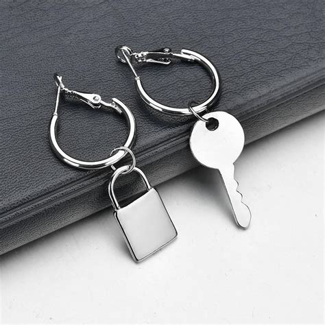 Lock asymmetrical earrings in metal .